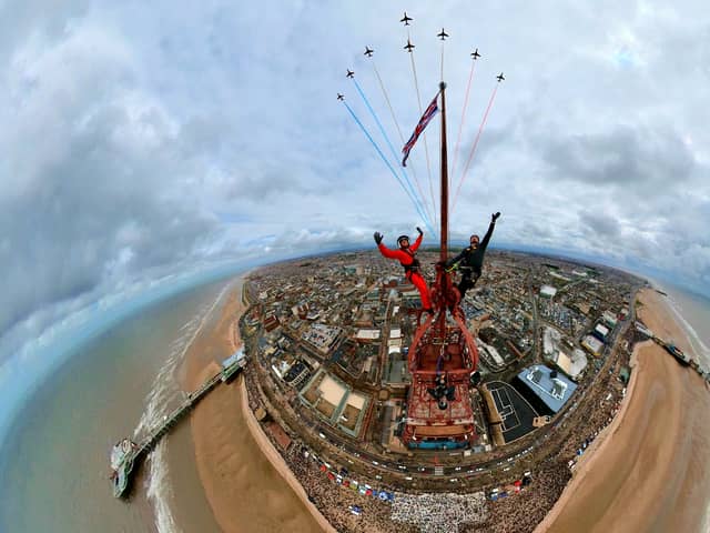 Two thrill-seekers have taken the ultimate selfie with the red arrows