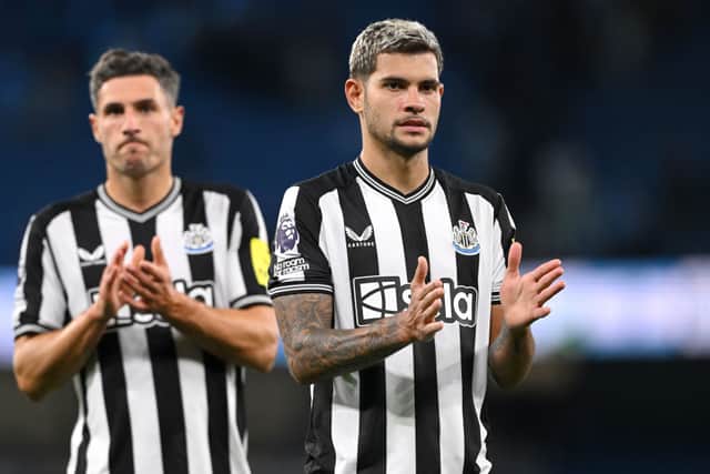 Bruno Guimaraes of Newcastle and Fabian Schar (l) react after the Premier League match between Manchester City and Newcastle United at Etihad Stadium on August 19, 2023 in Manchester, England. (Photo by Stu Forster/Getty Images)