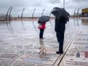 Holidaymakers brave the rain on Blackpool promenade on August 14.
