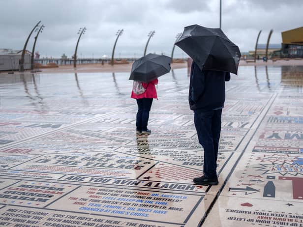 Holidaymakers brave the rain on Blackpool promenade on August 14.