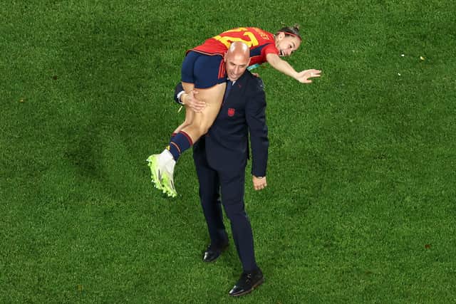 This picture taken on August 20, 2023 shows President of the Royal Spanish Football Federation Luis Rubiales carrying Spain's Athenea del Castillo Beivide on his shoulder as they celebrate winning the Australia and New Zealand 2023 Women's World Cup final football match between Spain and England at Stadium Australia in Sydney.