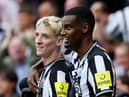 Anthony Gordon of Newcastle United celebrates with team mate Alexander Isak after scoring their sides first goal during the Premier League match between Newcastle United and Liverpool FC at St. James Park on August 27, 2023 in Newcastle upon Tyne, England.