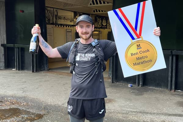 Ben Cook celebrating the completion of his 63 mile Metrothon challenge.