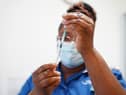 A nurse prepares a dose of a Covid-19 vaccine.