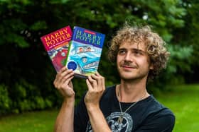 Max Roe with first edition copies of Harry Potter books his mum got him when he was young - one signed by JK Rowling could be worth £10,000.