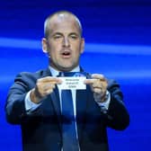 English former football player Joe Cole shows the paper slip of Newcastle United FC during the draw for the 2023/2024 UEFA Champions League football tournament at The Grimaldi Forum in the Principality of Monaco, on August 31, 2023. (Photo by NICOLAS TUCAT / AFP) (Photo by NICOLAS TUCAT/AFP via Getty Images)