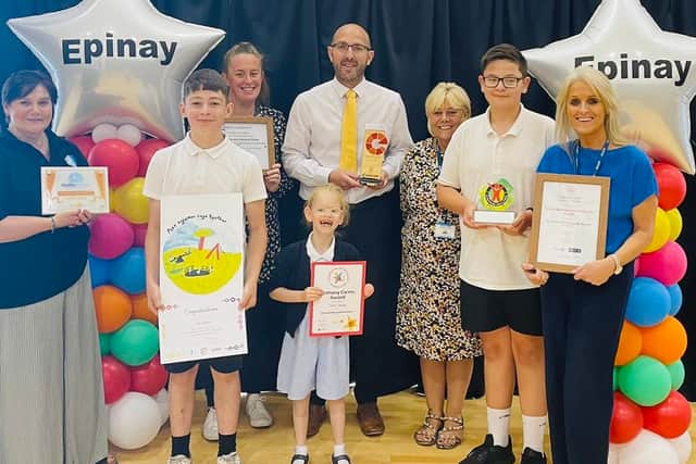 Epinay School headteacher Chris Rue (middle) with staff and pupils as they celebrate an ‘outstanding’ Ofsted inspection. Photo: Other 3rd Party.