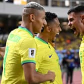 Brazil's forward Raphinha (C) celebrates with teammates forward Richarlison (L) and midfielder Bruno Guimaraes after scoring a goalduring the 2026 FIFA World Cup South American qualifiers football match between Brazil and Bolivia at the Jornalista Edgar ProenÃ§a 'Mangueirao' stadium, in Belem, state of Para, Brazil, on September 8, 2023. (Photo by CARL DE SOUZA / AFP) (Photo by CARL DE SOUZA/AFP via Getty Images)