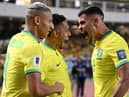 Brazil's forward Raphinha (C) celebrates with teammates forward Richarlison (L) and midfielder Bruno Guimaraes after scoring a goalduring the 2026 FIFA World Cup South American qualifiers football match between Brazil and Bolivia at the Jornalista Edgar ProenÃ§a 'Mangueirao' stadium, in Belem, state of Para, Brazil, on September 8, 2023. (Photo by CARL DE SOUZA / AFP) (Photo by CARL DE SOUZA/AFP via Getty Images)