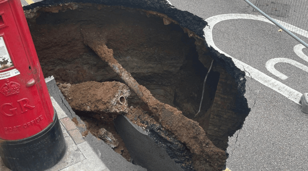 Mysterious sinkhole appears in UK and almost gobbles post box - motorists beware 
