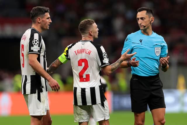 Fabian Schar and Kieran Trippier of Newcastle United interact with Referee Jose Maria Sanchez Martinez during the UEFA Champions League Group F match between AC Milan and Newcastle United FC at Stadio Giuseppe Meazza on September 19, 2023 in Milan, Italy. (Photo by Emilio Andreoli/Getty Images)