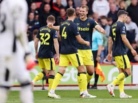Sven Botman celebrates with Dan Burn of Newcastle United after scoring the team's third goal during the Premier League match between Sheffield United and Newcastle United at Bramall Lane on September 24, 2023 in Sheffield, England. (Photo by George Wood/Getty Images)