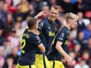 Dan Burn of Newcastle United celebrates with teammates after scoring the team’s second goal during the Premier League match between Sheffield United and Newcastle United at Bramall Lane on September 24, 2023 in Sheffield, England. (Photo by George Wood/Getty Images)