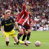  Anthony Gordon of Newcastle United is challenged by Jayden Bogle of Sheffield United during the Premier League match between Sheffield United and Newcastle United at Bramall Lane on September 24, 2023 in Sheffield, England. (Photo by George Wood/Getty Images)