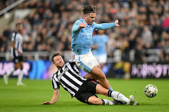 Paul Dummett tackles Jack Grealish