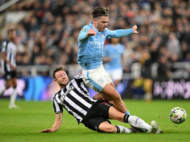 Paul Dummett tackles Jack Grealish