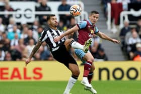 Bruno Guimaraes of Newcastle United and Josh Cullen of Burnley battle for the ball during the Premier League match between Newcastle United and Burnley FC at St. James Park on September 30, 2023 in Newcastle upon Tyne, England. 