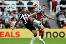 Bruno Guimaraes of Newcastle United and Josh Cullen of Burnley battle for the ball during the Premier League match between Newcastle United and Burnley FC at St. James Park on September 30, 2023 in Newcastle upon Tyne, England. 