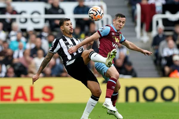 Bruno Guimaraes of Newcastle United and Josh Cullen of Burnley battle for the ball during the Premier League match between Newcastle United and Burnley FC at St. James Park on September 30, 2023 in Newcastle upon Tyne, England. 