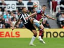 Bruno Guimaraes of Newcastle United and Josh Cullen of Burnley battle for the ball during the Premier League match between Newcastle United and Burnley FC at St. James Park on September 30, 2023 in Newcastle upon Tyne, England. 