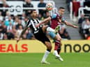 Bruno Guimaraes of Newcastle United and Josh Cullen of Burnley battle for the ball during the Premier League match between Newcastle United and Burnley FC at St. James Park on September 30, 2023 in Newcastle upon Tyne, England. 