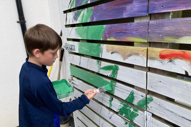 Henry Macdonald, aged 12, has been helping Sheila with the mural.