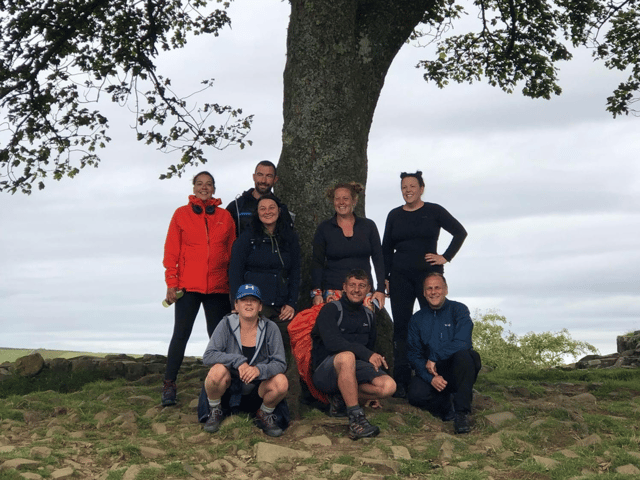 Back left to right:  Alison Wilson, Simon Tate, Angie Comerford, Kirsty Robson, and Stephanie McDowell. Front left to right: Emma Butler, Steph Comerford and Paul Rogers under the Sycamore Gap tree.