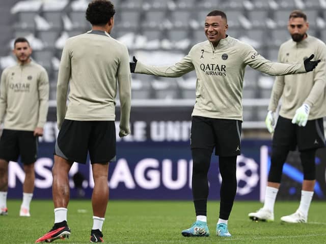 Paris Saint-Germain's French forward #07 Kylian Mbappe (2R) talks with Paris Saint-Germain's Brazilian defender #05 Marquinhos (2L) during a team training session at St James's Park stadium in Newcastle-upon-Tyne, north east England on October 3, 2023, on the eve of their UEFA Champions League group F football match against Newcastle United. (Photo by FRANCK FIFE / AFP) (Photo by FRANCK FIFE/AFP via Getty Images)