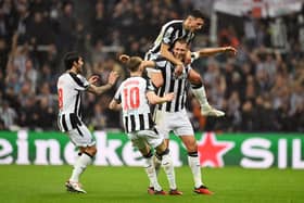 Dan Burn celebrates scoring for Newcastle United against Paris Saint-Germain.  
