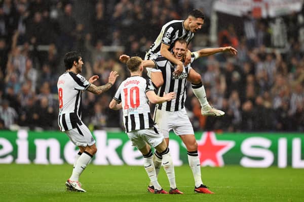 Dan Burn celebrates scoring for Newcastle United against Paris Saint-Germain.  