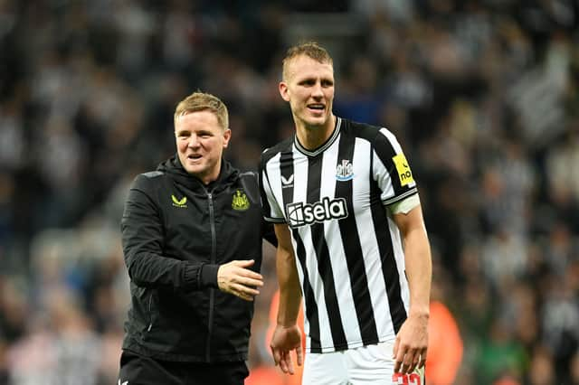 Eddie Howe alongside Dan Burn following the win over PSG.