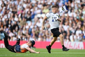 Leeds United fan invades the pitch.  