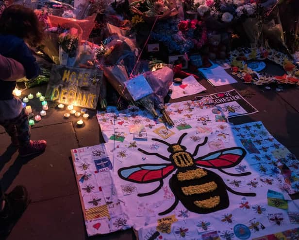 Flowers and balloons are placed in central Manchester on May 22, 2018, the one year anniversary of the deadly attack at Manchester Arena. 