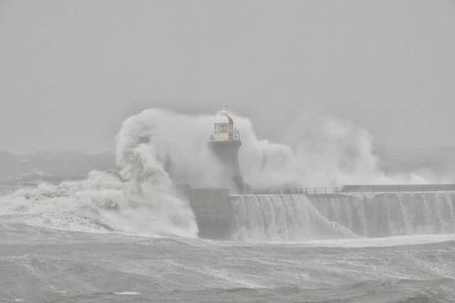 South Shields lighthouse being battered by waves.