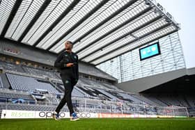 Joe Willock of Newcastle United inspects the pitch prior to the UEFA Champions League match between Newcastle United FC and Borussia Dortmund at St. James Park on October 25, 2023 in Newcastle upon Tyne, England. (Photo by Michael Regan/Getty Images)