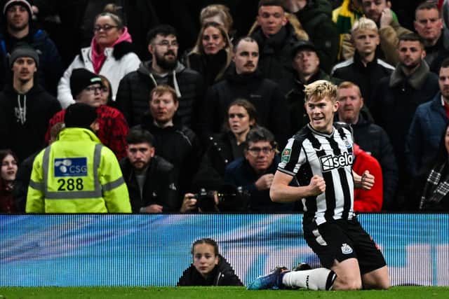 Newcastle United left-back Lewis Hall celebrates scroing against Manchester United. (Photo by PAUL ELLIS/AFP via Getty Images)