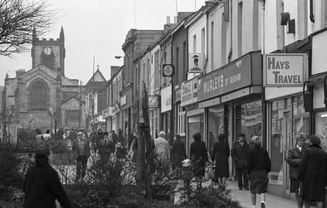 It's a cold but busy day In Seaham in this 1983 walk down Church Street.
How about a look in Hays Travel.