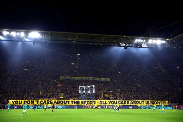 Borussia Dortmund fans hold a banner up reading 'You don't care about the sport - All you care about is money!' during the UEFA Champions League match between Borussia Dortmund and Newcastle United at Signal Iduna Park on November 07, 2023 in Dortmund, Germany. (Photo by Alex Grimm/Getty Images)