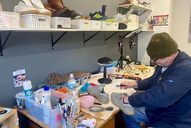 James working on a pair of trainers.