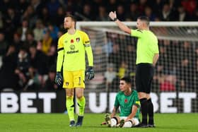 Newcastle United's Paraguayan midfielder #24 Miguel Almiron (C) reacts after being injured during the English Premier League football match between Bournemouth and Newcastle united at the Vitality Stadium in Bournemouth, southern England on November 11, 2023. (Photo by Adrian DENNIS / AFP)