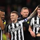 Trippier, Livramento and Wilson after the Manchester United win.