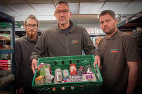 CEO Peter Maloney (middle) with team members Joe and Johnny showcasing a typical food parcel
Credit: Wayne Madden of Hospitality and Hope