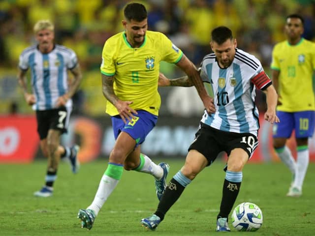 Argentina's forward Lionel Messi (R) and Brazil's midfielder Bruno Guimaraes fight for the ball during the 2026 FIFA World Cup South American qualification football match between Brazil and Argentina. (Photo by CARL DE SOUZA / AFP) (Photo by CARL DE SOUZA/AFP via Getty Images)
