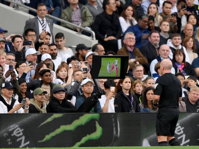 Referee, Simon Hooper watches the Video Assistant Referee before awarding a red card to Curtis Jones of Liverpool during the Premier League match between Tottenham Hotspur and Liverpool. (Photo by Justin Setterfield/Getty Images)