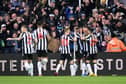 Alexander Isak of Newcastle United (obscured) celebrates with teammates after scoring the team's first goal during the Premier League match between Newcastle United and Chelsea FC at St. James Park on November 25, 2023 in Newcastle upon Tyne, England. (Photo by Stu Forster/Getty Images)