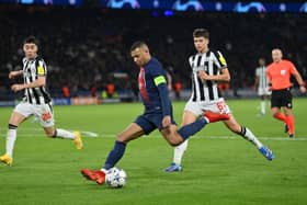 Kylian Mbappe of Paris Saint-Germain shoots whilst under pressure from Lewis Miley of Newcastle United during the UEFA Champions League match between Paris Saint-Germain and Newcastle United FC at Parc des Princes on November 28, 2023 in Paris, France. (Photo by Justin Setterfield/Getty Images)