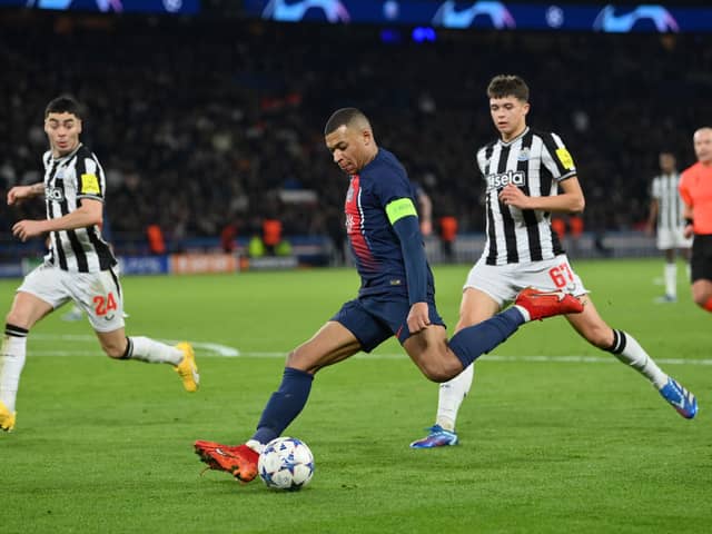 Kylian Mbappe of Paris Saint-Germain shoots whilst under pressure from Lewis Miley of Newcastle United during the UEFA Champions League match between Paris Saint-Germain and Newcastle United FC at Parc des Princes on November 28, 2023 in Paris, France. (Photo by Justin Setterfield/Getty Images)
