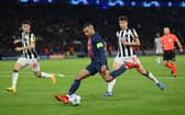 Kylian Mbappe of Paris Saint-Germain shoots whilst under pressure from Lewis Miley of Newcastle United during the UEFA Champions League match between Paris Saint-Germain and Newcastle United FC at Parc des Princes on November 28, 2023 in Paris, France. (Photo by Justin Setterfield/Getty Images)