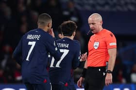 Paris Saint-Germain's French forward #07 Kylian Mbappe (L) and team mates call for a penalty to Polish referee Szymon Marciniak (R) during the UEFA Champions League 1st round, day 5, Group F football match between Paris Saint-Germain (PSG) and Newcastle United on November 28, 2023 at the Parc des Princes stadium in Paris. (Photo by FRANCK FIFE / AFP) (Photo by FRANCK FIFE/AFP via Getty Images)