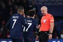 Paris Saint-Germain's French forward #07 Kylian Mbappe (L) and team mates call for a penalty to Polish referee Szymon Marciniak (R) during the UEFA Champions League 1st round, day 5, Group F football match between Paris Saint-Germain (PSG) and Newcastle United on November 28, 2023 at the Parc des Princes stadium in Paris. (Photo by FRANCK FIFE / AFP) (Photo by FRANCK FIFE/AFP via Getty Images)